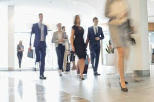 blurred people walking through corporate building