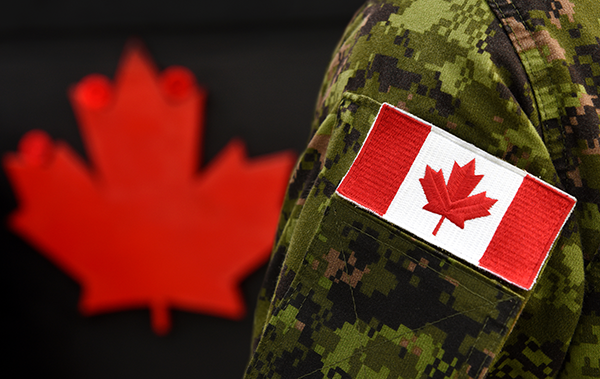Canadian flag sewn on arm of military uniform